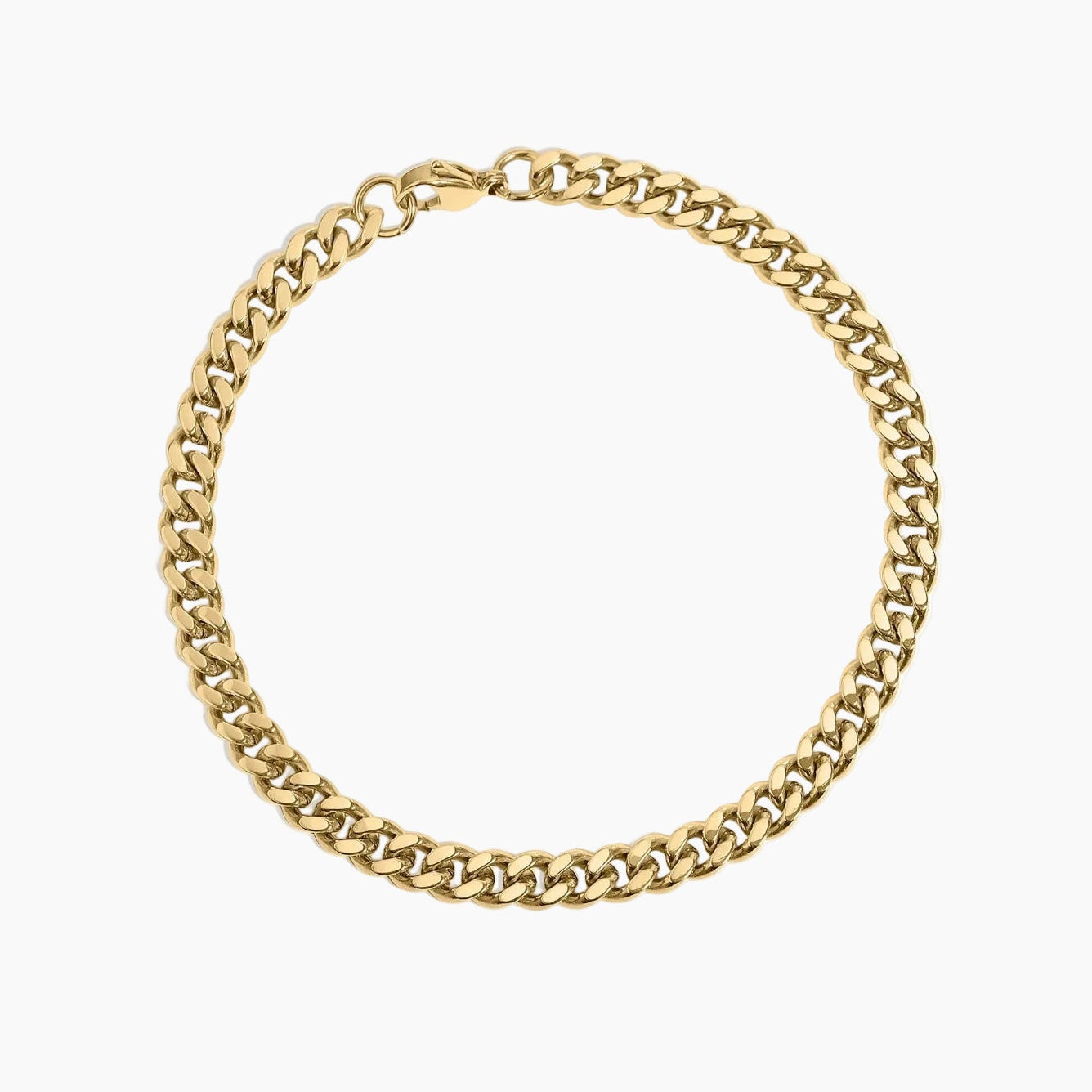 Gold chain bracelet laying on white background