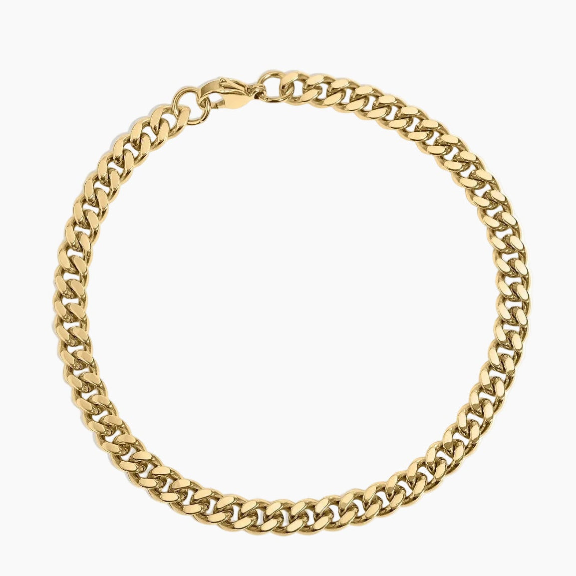 Gold chain bracelet laying on white background